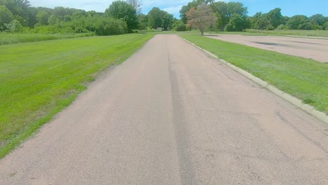 POV-thru-the-rear-window-while-driving-thru-a-rural-county-park-and-past-prairie-and-alfalfa-field-in-rural-South-Dakota