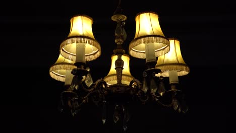 Old-British-Chandelier-Light-In-The-Dark-Hanging-In-A-Home-With-Slow-Push-In