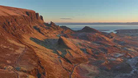 Landslip-crumbling-cliffs-bathed-in-dawn-light-with-slow-pan-reveal-of-moorland-and-sea-horizon