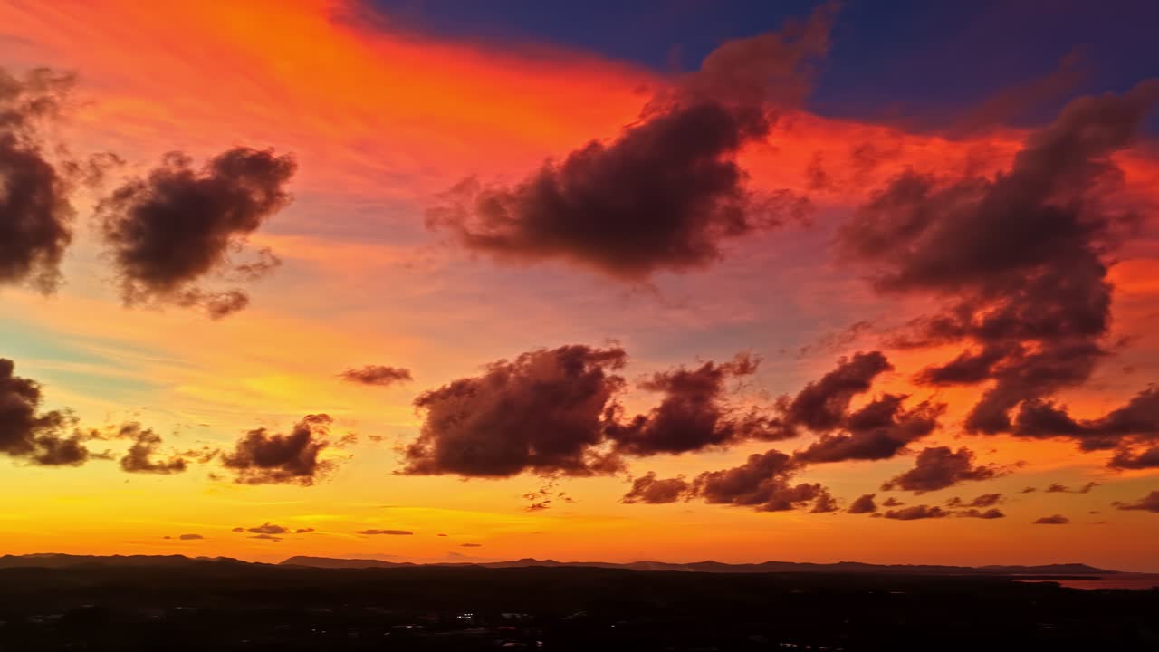 Fiery sunset colors fill the sky with dramatic clouds over Poblacion V, creating a breathtaking view