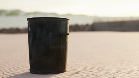 gray metal garbage bin or trash can on the beach