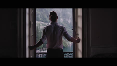man looking at a scenic view from a window