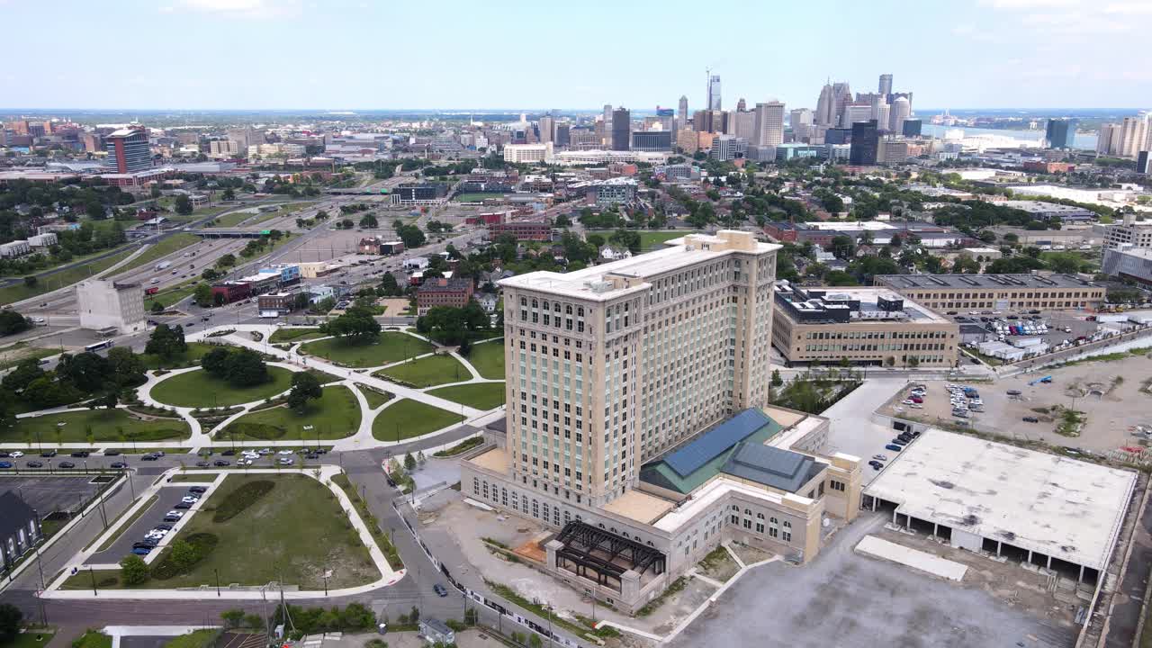 Michigan Central Station building in Corktown with skyline of Detroit in background, aerial view