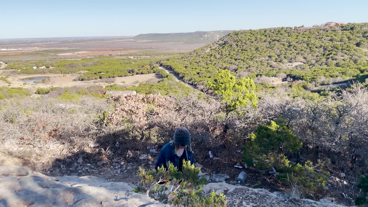 wide view of mountain as a person walks towards camera
