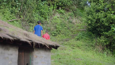 Indian boys holding hands while walking together in countryside fields, brotherhood and simplicity, 4k video