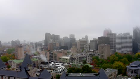 drone turning down and away from downtown montreal to a soccer field on a foggy day