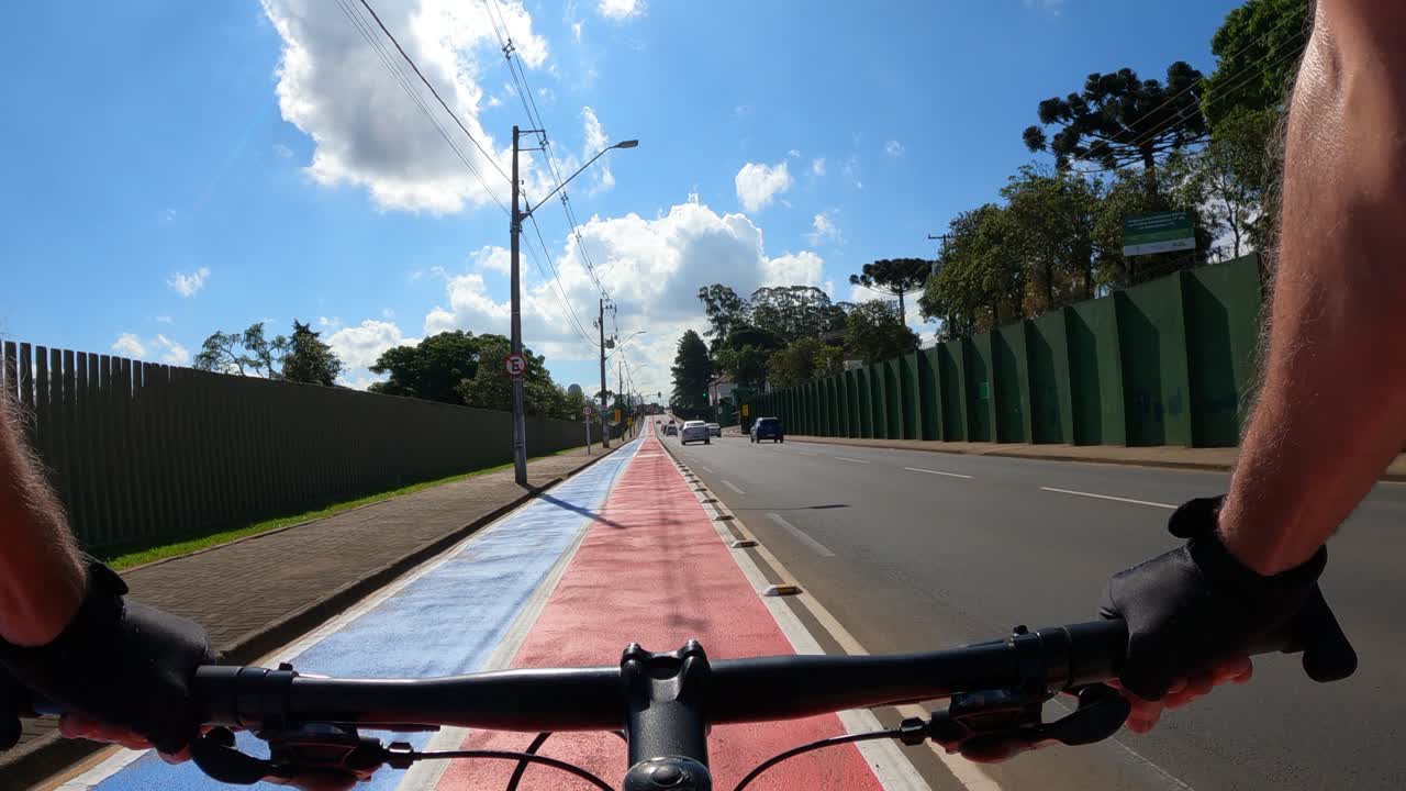 Cyclist under bike lane with signage on the ground, POV