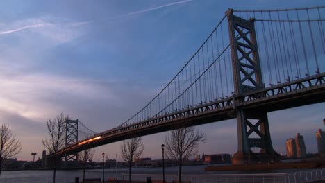 a commuter train crosses the ben franklin bridge near philadelphia pa