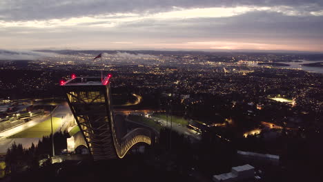 aerial view of holmenkollbakken with city views at night in oslo, norway