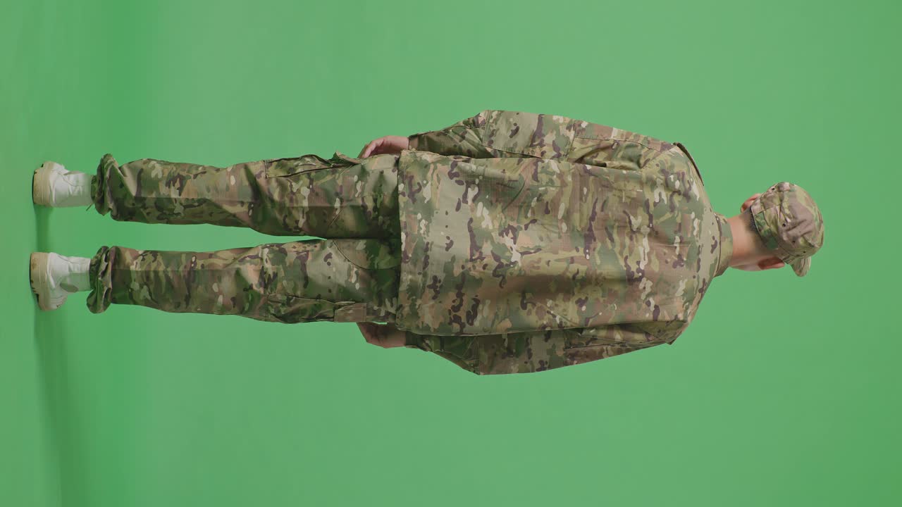 Full Body Of Back View Of Asian Man Soldier Looking Around While Standing In The Green Screen Background Studio
