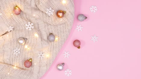 knitted sweater with christmas ornaments and blinking lights appear on pastel pink theme. stop motion