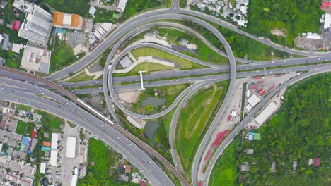 aerial view of highway junctions with roundabout. bridge roads shape circle in structure of architecture and transportation concept. top view. urban city, bangkok at sunset, thailand.