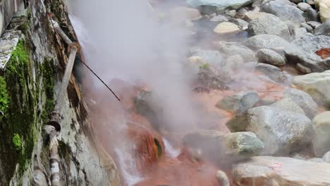 vapour rising form natural holy hot spring water at day