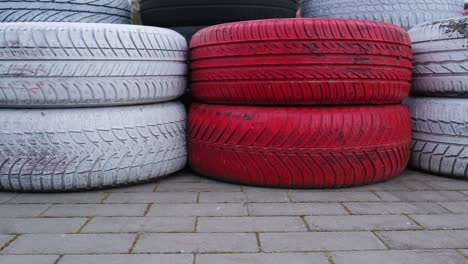 black red and white worn out car tyres used as karting track safety barriers