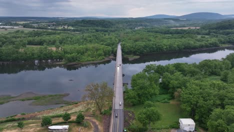 Susquehanna-River-and-Watsontown,-Pennsylvania-downtown-with-drone-video-pulling-back