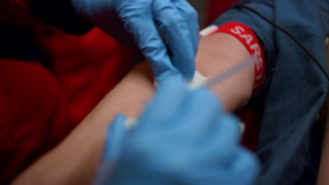 unrecognizable nurse rubbing man arm with sterile tissue