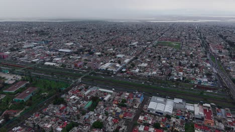 aerial drone footage of ecatepec on a grey, rainy afternoon