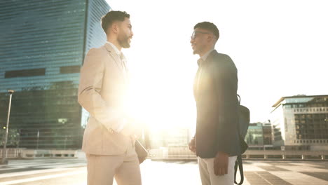 Men,-colleagues-and-talking-outside-in-city-as