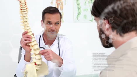 doctor explaining spine model to patient, medical information animation over scene