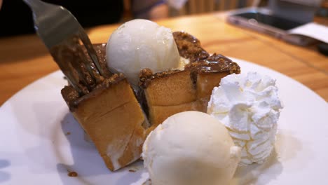 chocolate coated cake fudge with a ball of ice cream on top and on the side