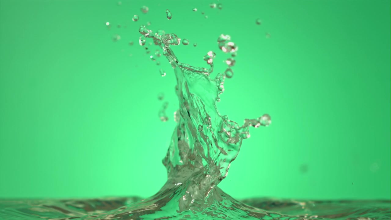 Water Splashing and Droplets Falling in Slow Motion on Green Background
