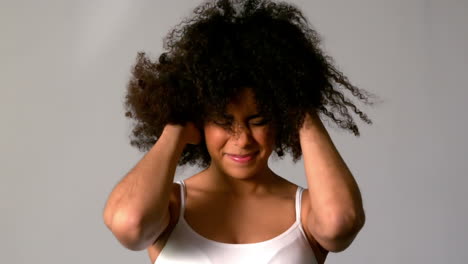 pretty girl with afro shaking her hair