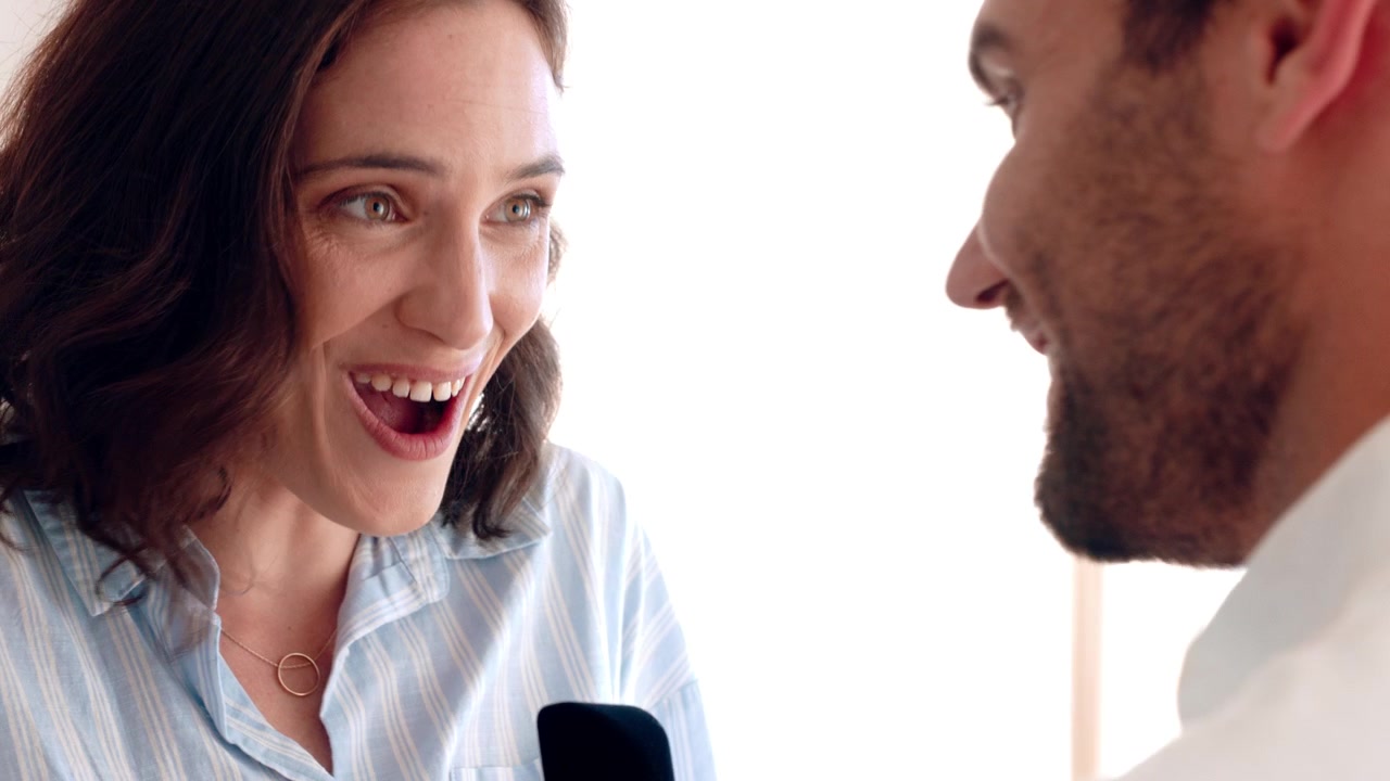 Man Proposing to Woman with Engagement Ring