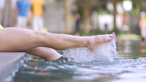 Woman legs splashing in the pool. Shot on super slow motion camera 1000 fps.