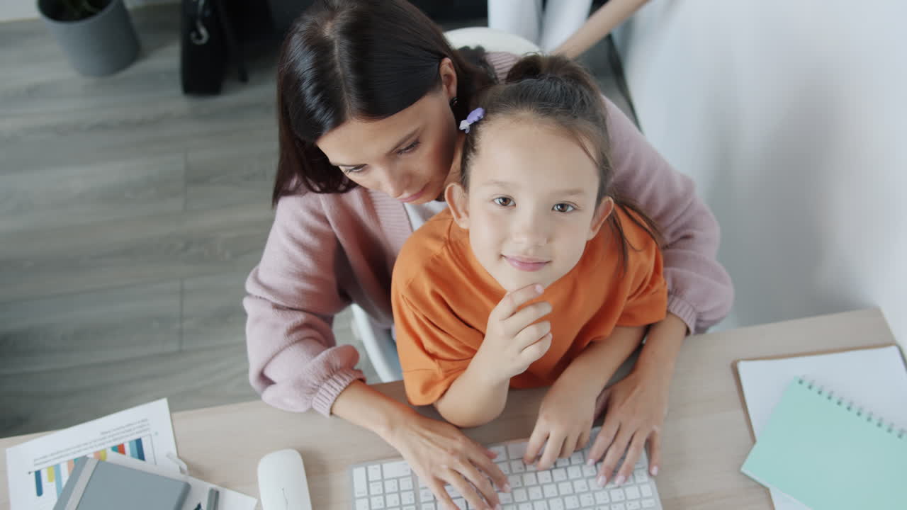 Mother and Daughter Working Together at Home