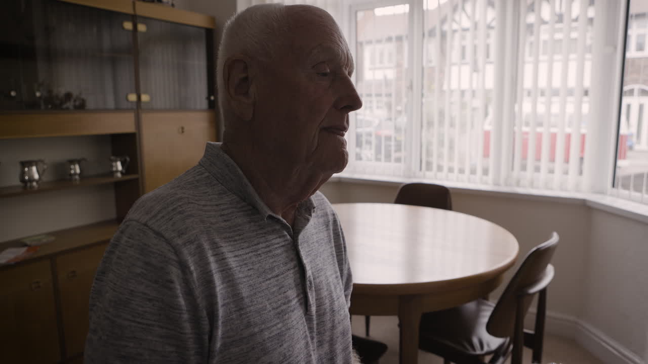 Elderly man playing keyboard at home