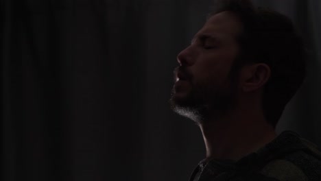 a man coughing loudly while expelling saliva into the air