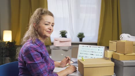 e-commerce woman makes positive gesture at camera.