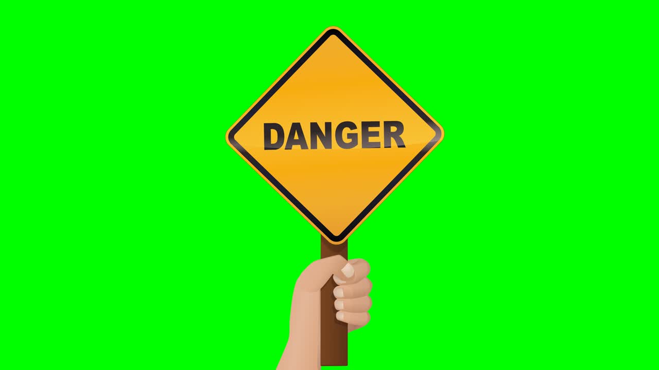 A hand presents a diamond shaped danger sign on green background
