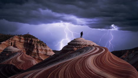 lightning storm over striated rock formations with silhouetted figures