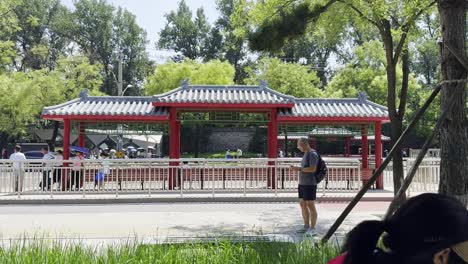 people waiting at a traditional chinese bus stop