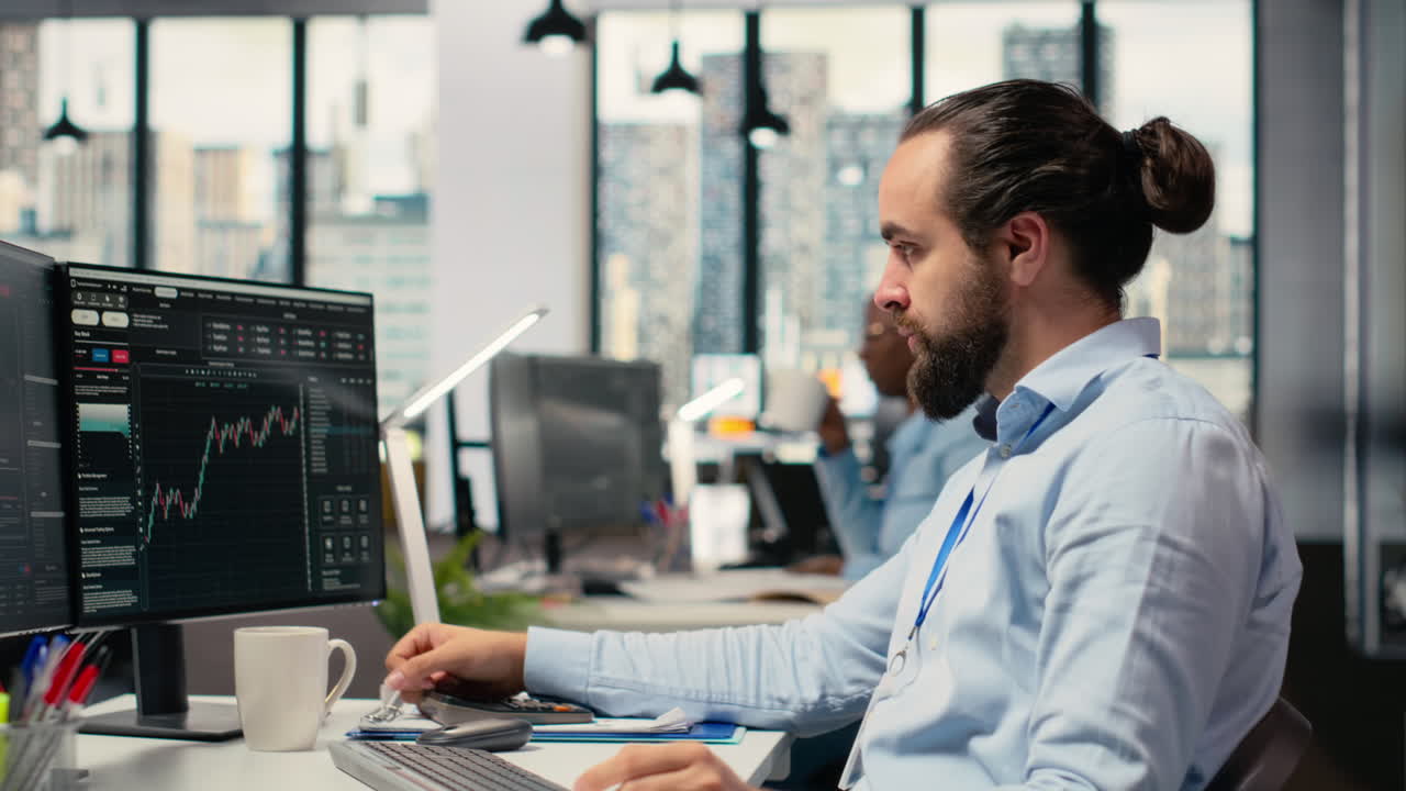 Trader covering face in disbelief, concerned by investment portfolio value drop