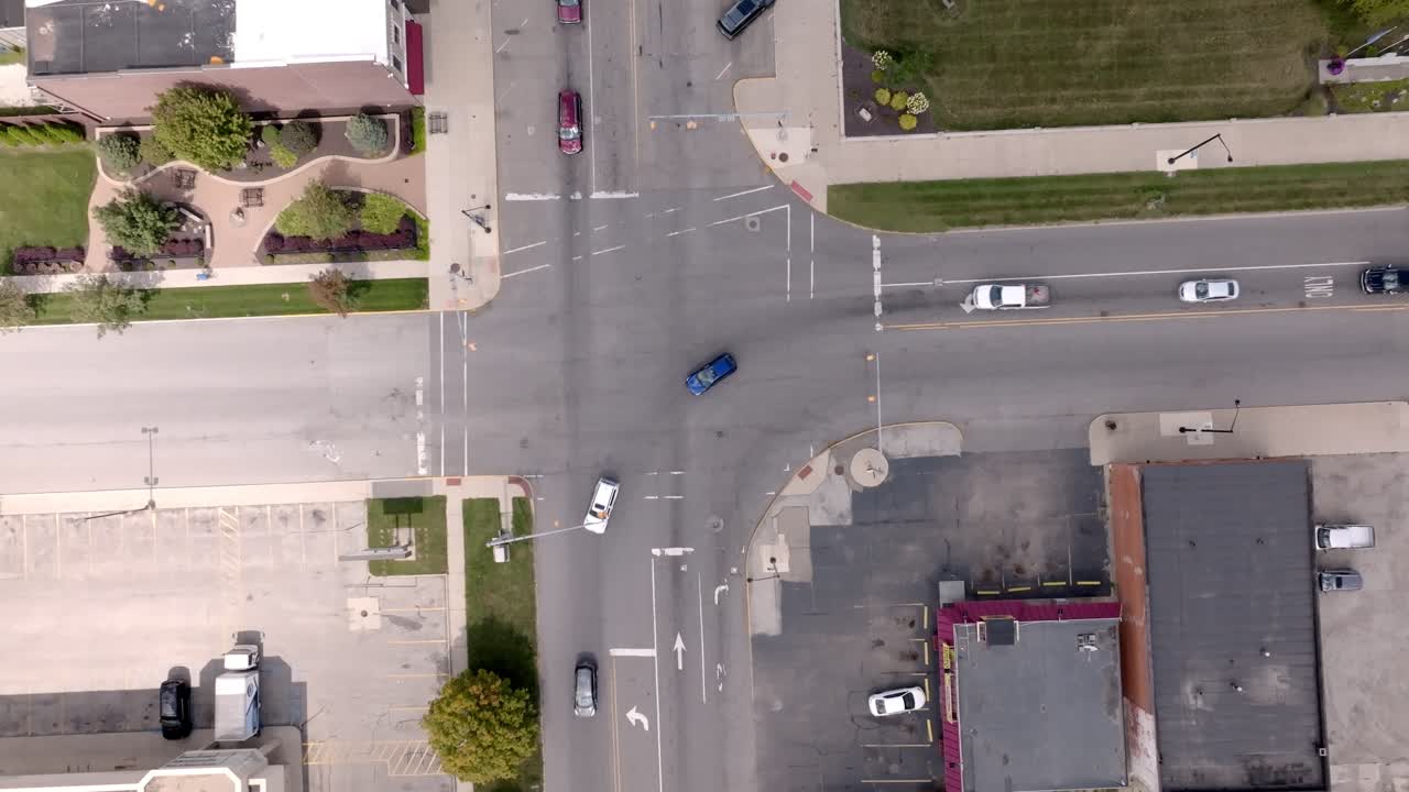 Downtown Rochester, Indiana traffic intersection with drone video overhead