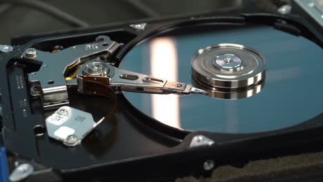 4k close up of a hard disk drive reading and writing data and internal structure for computer pc or server and cloud technology.