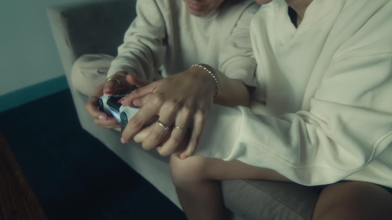 Two Women Playing Video Games on a Couch