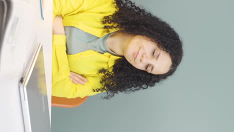 Vertical-video-of-Young-woman-closing-laptop-with-angry-expression.