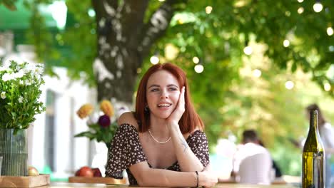 mujer sentada en una mesa de café al aire libre