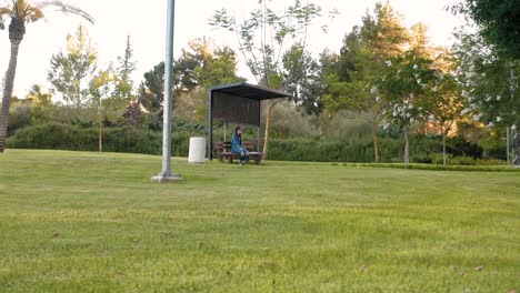 girl sits on a bench in the park