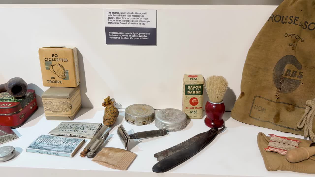 French World War II soldier artifacts displayed on a neutral background in a museum exhibit
