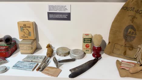 french world war ii soldier artifacts displayed on a neutral background in a museum exhibit