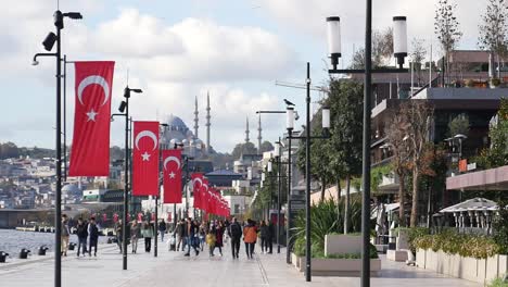 people walking along the waterfront in istanbul, turkey