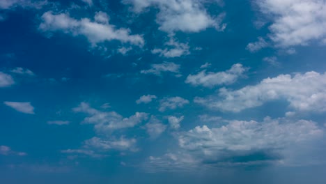 Mid-day-large-puffy-clouds-moving-away-with-blue-sky