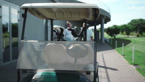 golf players sit cart get ready outside. active couple going drive car on course