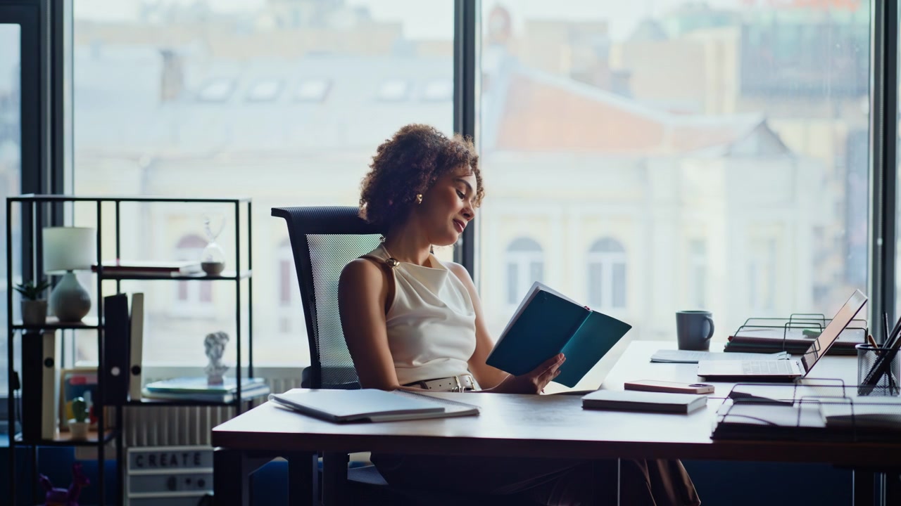 Businesswoman reading notebook thinking. Professional writing ideas at office