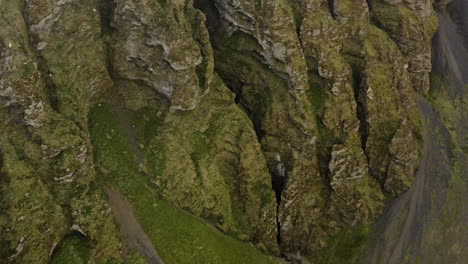 dramatic rocky cliffs on iceland's snaefellsnes peninsula, aerial pullback