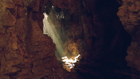 sunlight streaming into a rocky cave revealing hidden beauty at dawn